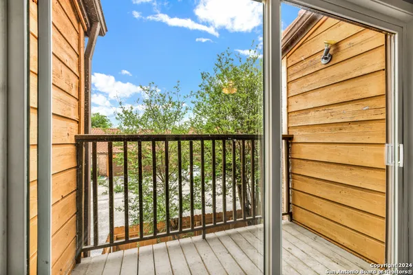 a view of a balcony with wooden floor