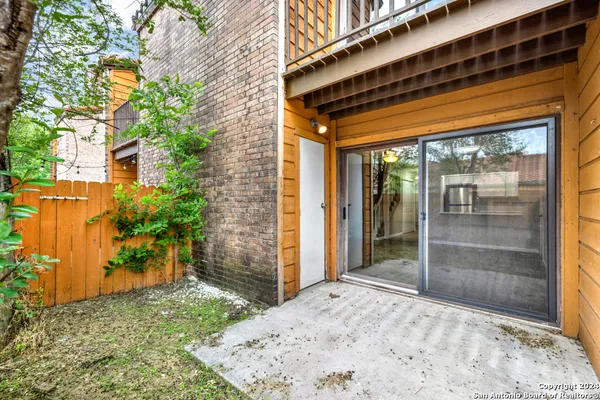 a backyard of a house with a tree