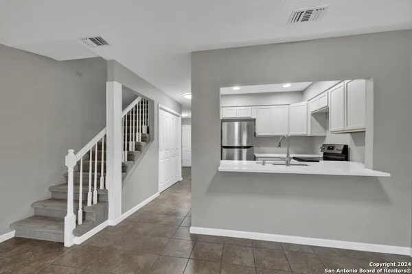 a kitchen with stainless steel appliances a sink and cabinets