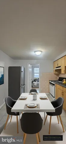 a room with table chairs and wooden floor