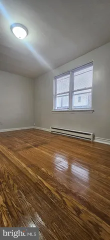 a view of a room with wooden floor and window