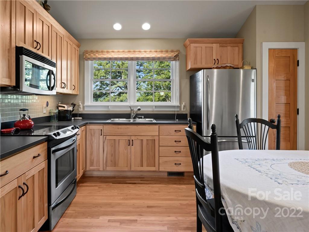 116 Stone Brook Trail Black Mountain, NC 28711 - Photo 11 of 48 a kitchen with stainless steel appliances granite countertop a sink stove and refrigerator