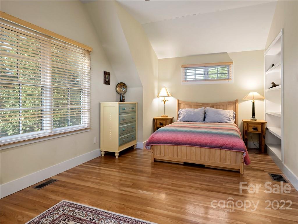 116 Stone Brook Trail Black Mountain, NC 28711 - Photo 17 of 48 a bedroom with a bed and wooden floor