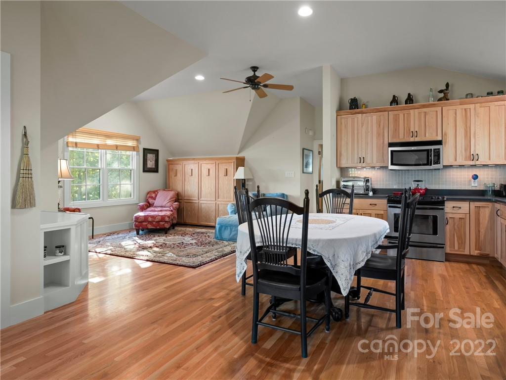 116 Stone Brook Trail Black Mountain, NC 28711 - Photo 9 of 48 a view of a dining room with furniture a rug and wooden floor
