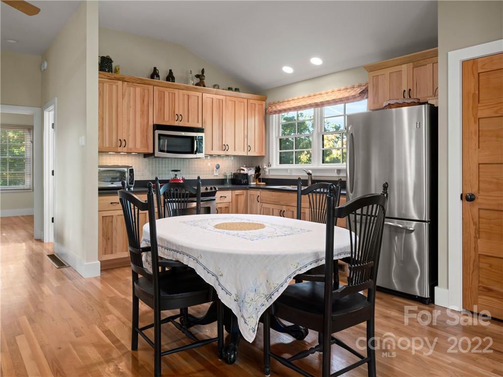 116 Stone Brook Trail Black Mountain, NC 28711 - Photo 10 of 48 a view of a dining room with furniture window and wooden floor