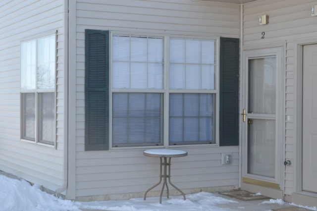 10187 Marblewing Road, Unit 2 Roscoe, IL 61073 - Photo 2 of 12 a view of entryway with a table and chair