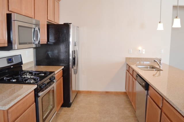 10187 Marblewing Road, Unit 2 Roscoe, IL 61073 - Photo 4 of 12 a kitchen with a stove and a refrigerator