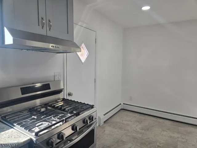 a stove top oven sitting inside of a kitchen