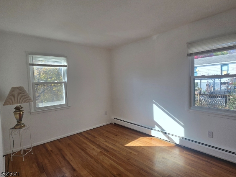 14 West Sterling Street, Unit 2 Wharton, NJ 07885 - Photo 24 of 35 an empty room with wooden floor and windows