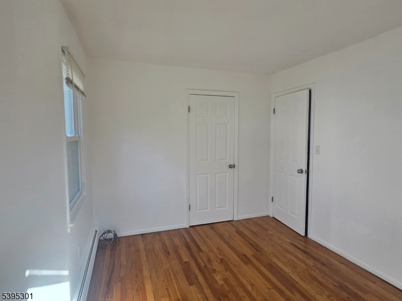14 West Sterling Street, Unit 2 Wharton, NJ 07885 - Photo 26 of 35 a view of an empty room and wooden floor