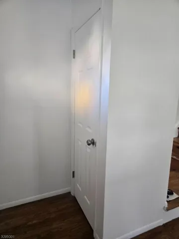 a view of room with wooden floor