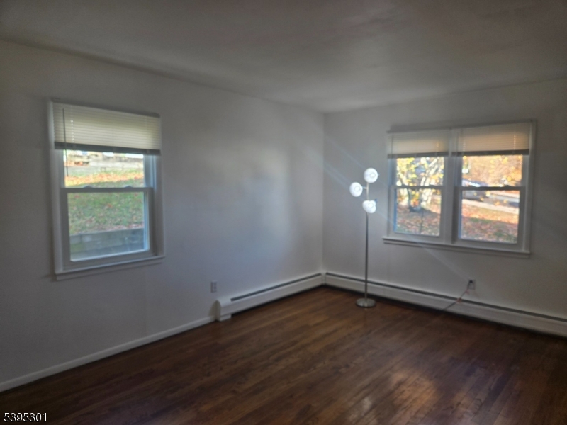 14 West Sterling Street, Unit 2 Wharton, NJ 07885 - Photo 9 of 35 an empty room with wooden floor and windows
