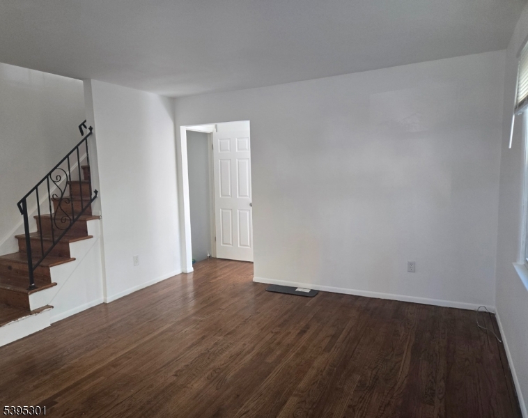 14 West Sterling Street, Unit 2 Wharton, NJ 07885 - Photo 10 of 35 a view of an empty room with wooden floor and stairs