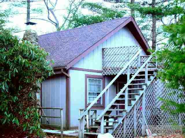 a front view of house with a garden