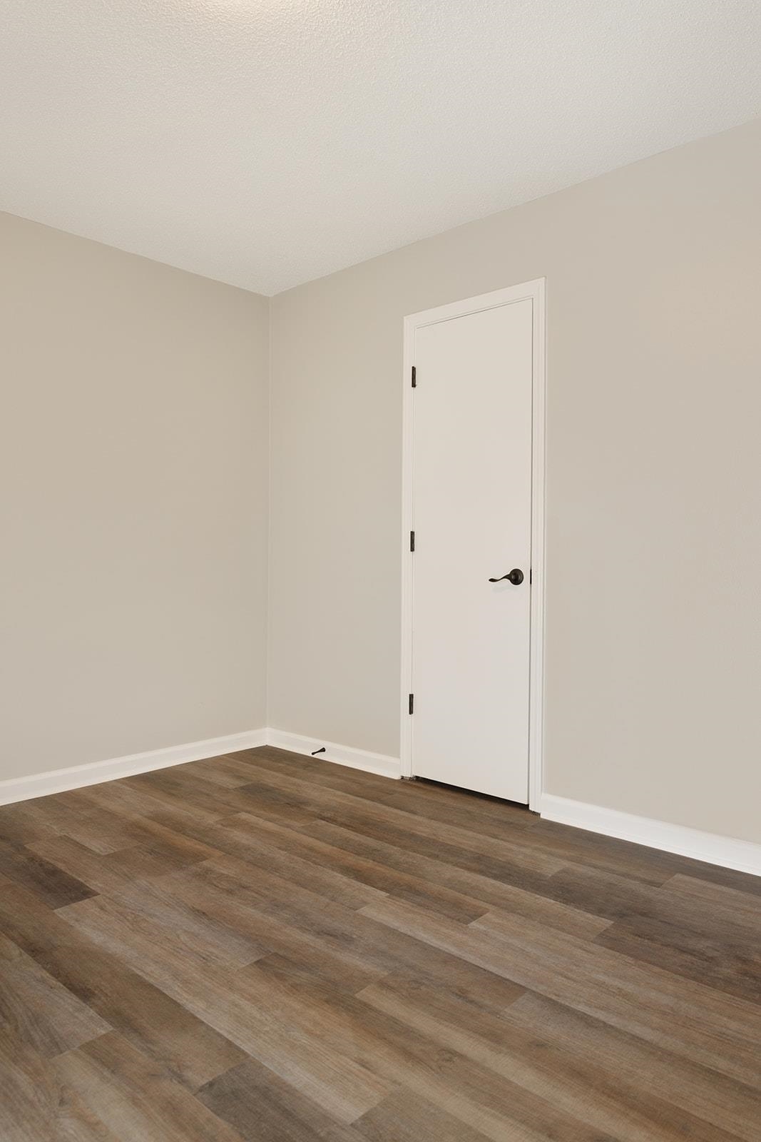 6976 Rockingham Road Memphis, TN 38125 - Photo 11 of 24 a view of an empty room with wooden floor