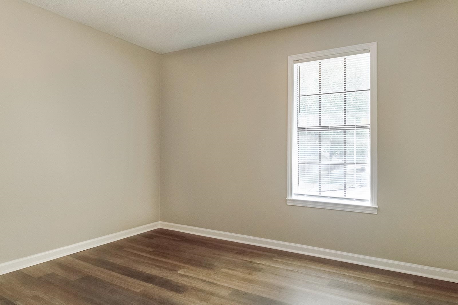6976 Rockingham Road Memphis, TN 38125 - Photo 17 of 24 an empty room with wooden floor and windows