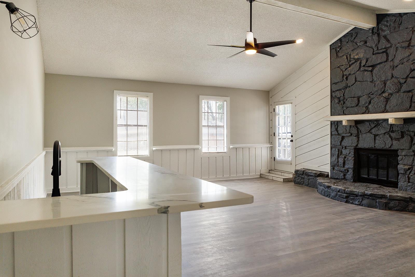 6976 Rockingham Road Memphis, TN 38125 - Photo 19 of 24 a view of a kitchen with a sink a fireplace and windows