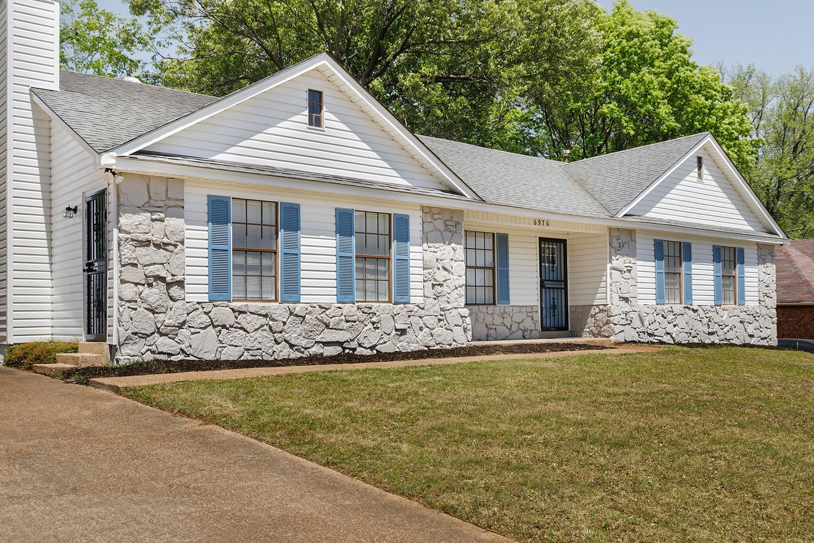 6976 Rockingham Road Memphis, TN 38125 - Photo 2 of 24 a front view of a house with a yard