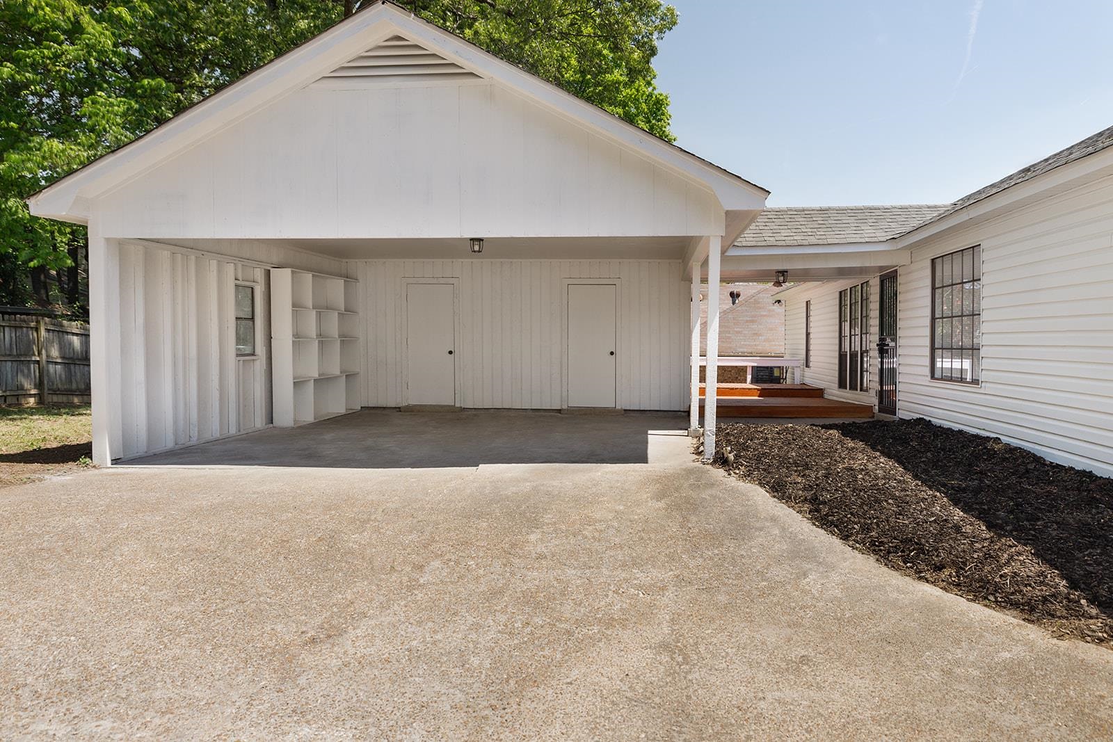 6976 Rockingham Road Memphis, TN 38125 - Photo 23 of 24 a view of a house with a backyard and garage