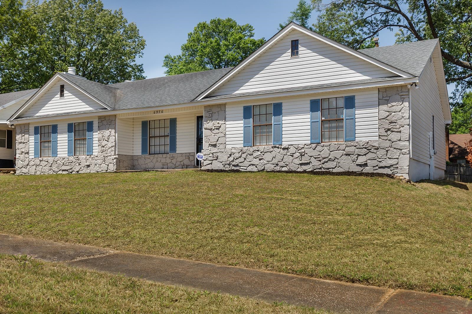 6976 Rockingham Road Memphis, TN 38125 - Photo 3 of 24 a front view of a house with garden
