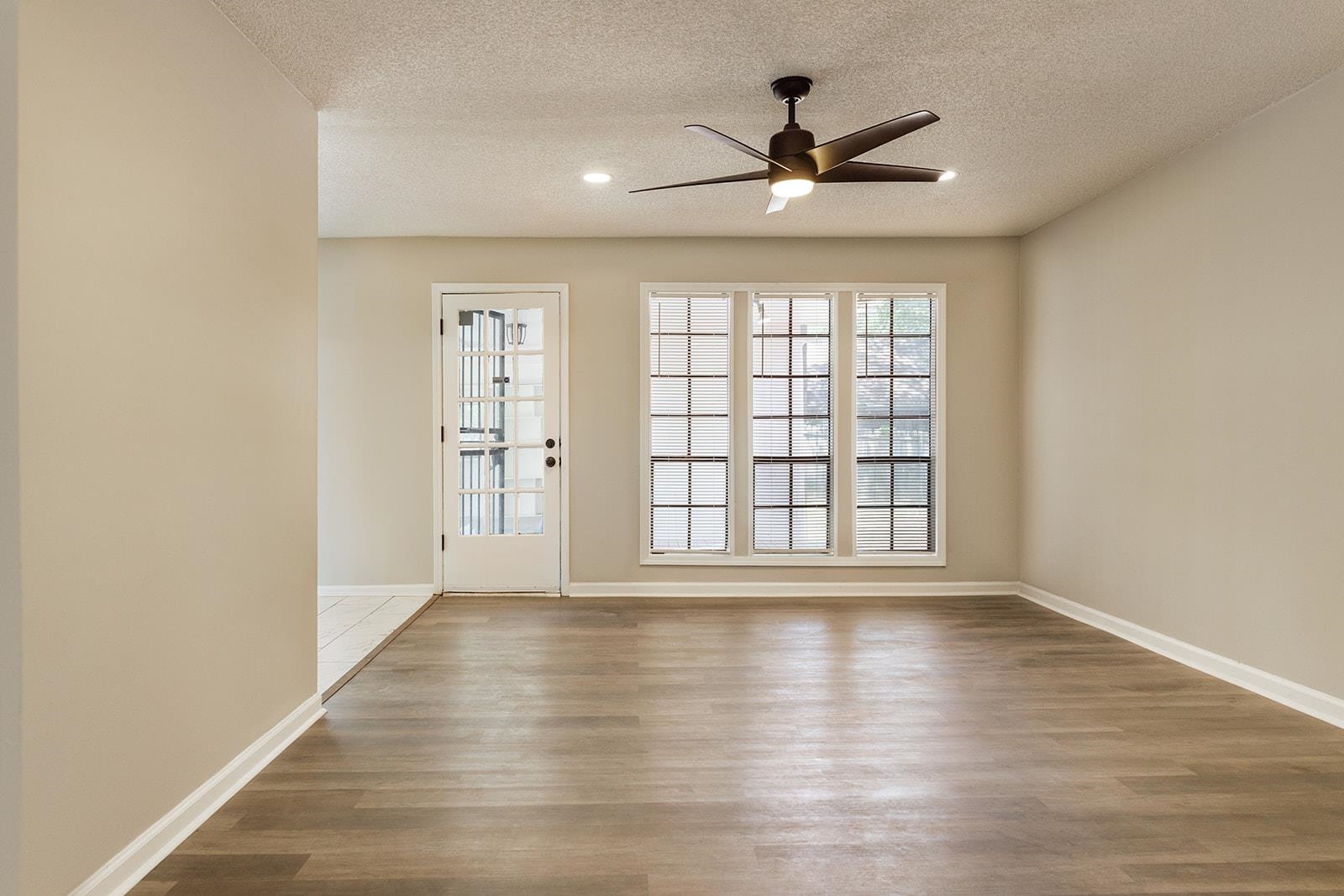 6976 Rockingham Road Memphis, TN 38125 - Photo 4 of 24 a view of an empty room with wooden floor and a window