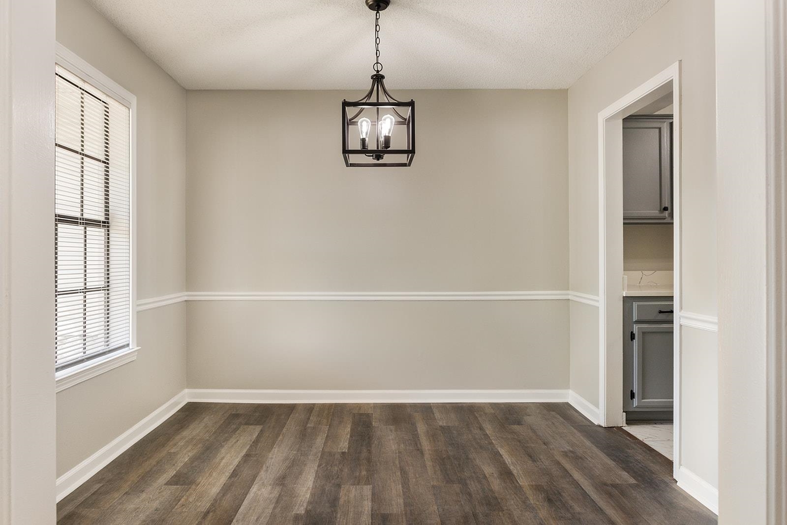 6976 Rockingham Road Memphis, TN 38125 - Photo 5 of 24 an empty room with windows and white walls