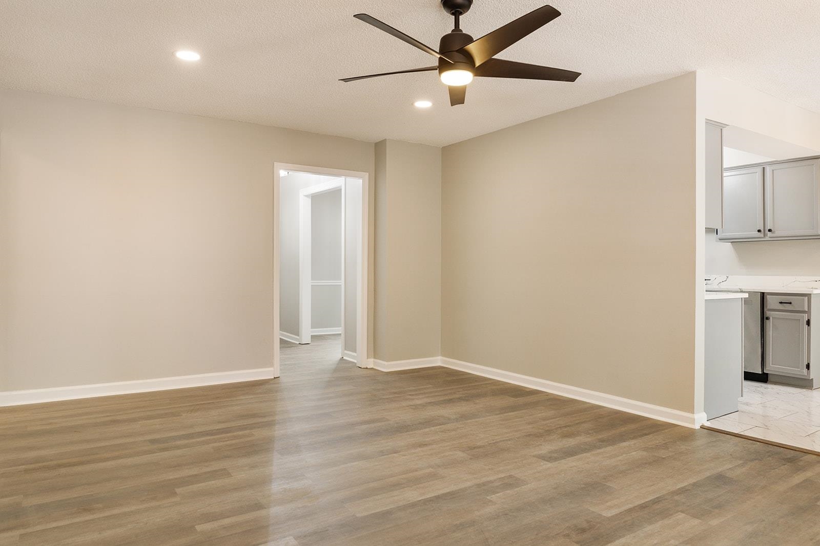 6976 Rockingham Road Memphis, TN 38125 - Photo 8 of 24 an empty room with wooden floor and windows