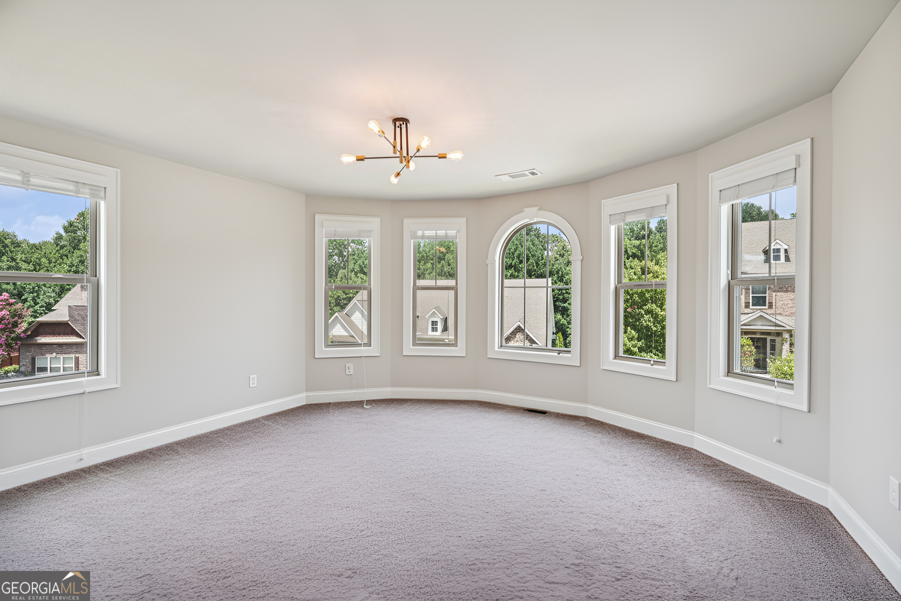 17 Lake Sydney Drive Dawsonville, GA 30534 - Photo 36 of 100 an empty room with windows and chandelier