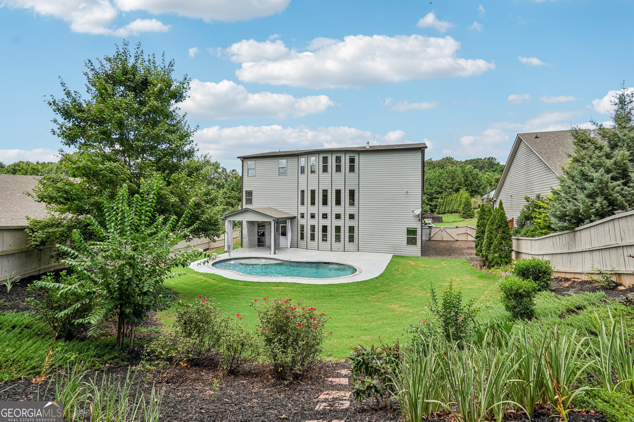 17 Lake Sydney Drive Dawsonville, GA 30534 - Photo 74 of 100 a view of a house with a backyard and a garden