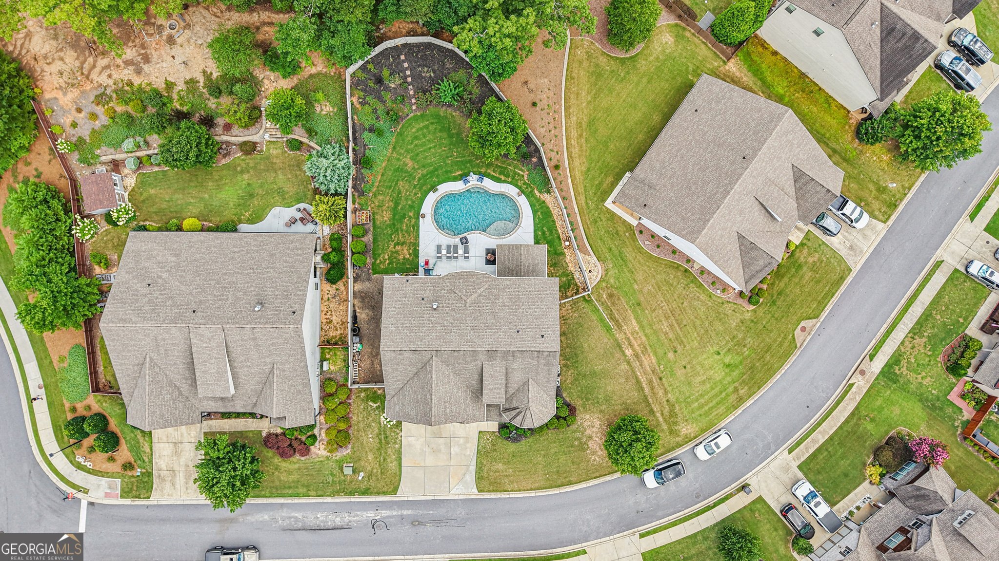 17 Lake Sydney Drive Dawsonville, GA 30534 - Photo 77 of 100 an aerial view of a house with swimming pool garden and tall trees