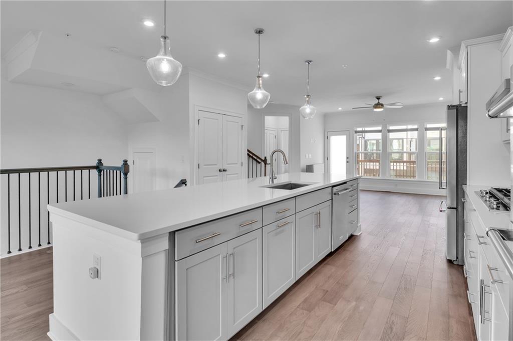 545 Whitlox Road Northwest Atlanta, GA 30309 - Photo 11 of 65 a large white kitchen with a sink and dish washer