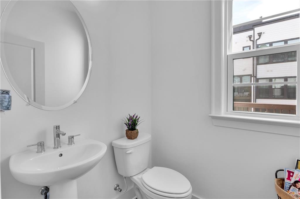 545 Whitlox Road Northwest Atlanta, GA 30309 - Photo 12 of 65 a white toilet sitting next to a bathroom sink