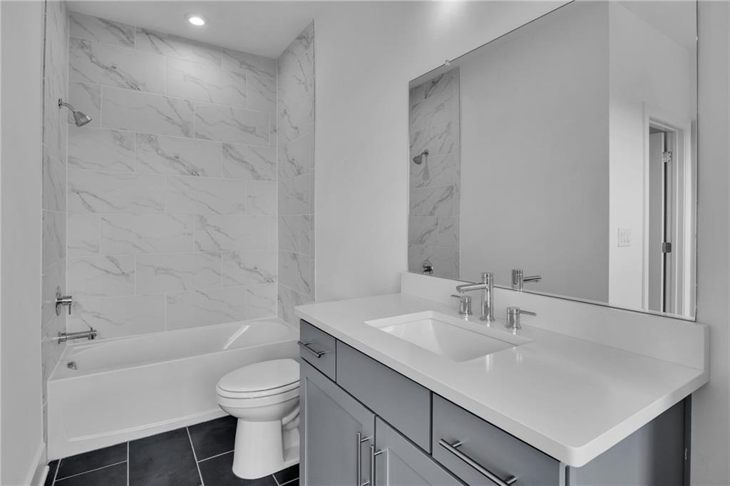 545 Whitlox Road Northwest Atlanta, GA 30309 - Photo 17 of 65 a bathroom with a sink a toilet and shower
