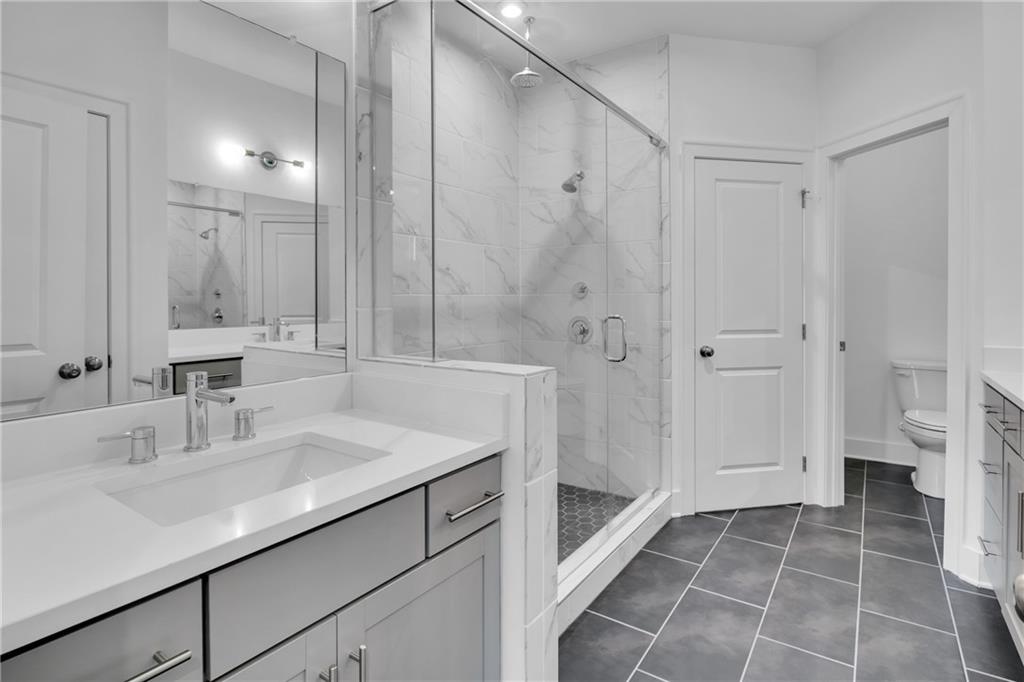545 Whitlox Road Northwest Atlanta, GA 30309 - Photo 25 of 65 a bathroom with a sink shower and a toilet
