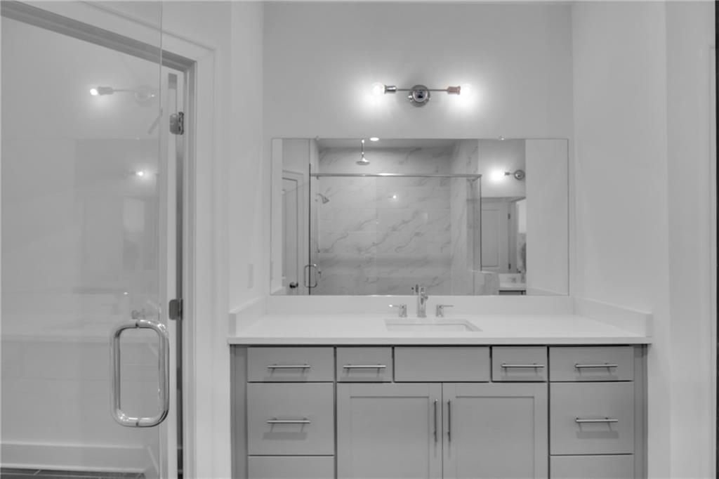 545 Whitlox Road Northwest Atlanta, GA 30309 - Photo 27 of 65 a bathroom with a sink shower and a mirror