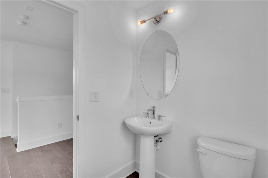 545 Whitlox Road Northwest Atlanta, GA 30309 - Photo 40 of 65 a bathroom with a sink toilet and a mirror