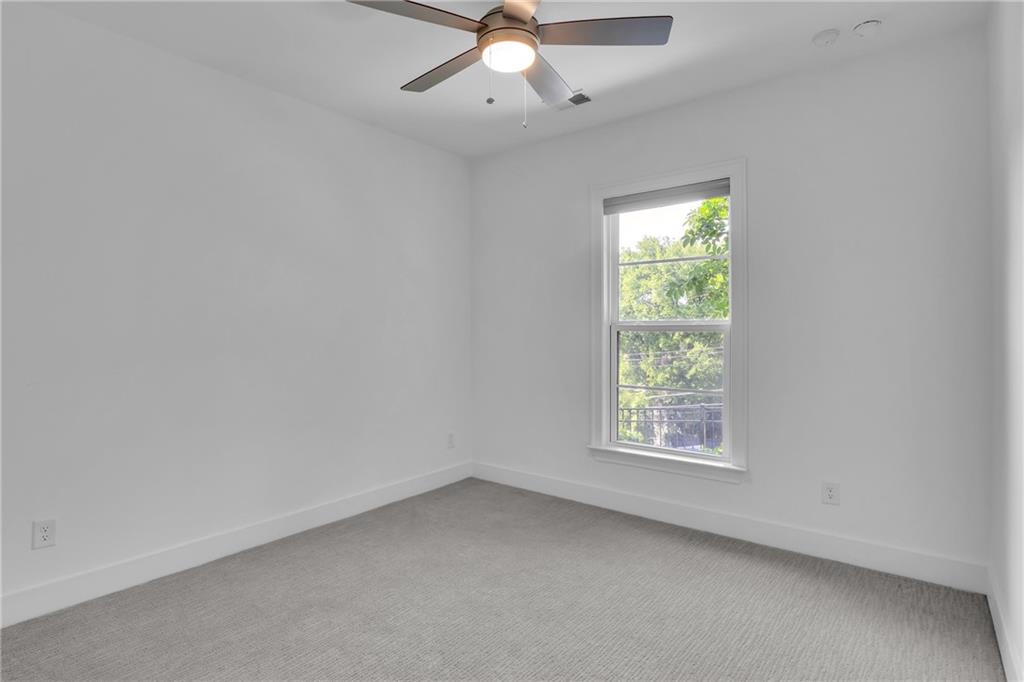 545 Whitlox Road Northwest Atlanta, GA 30309 - Photo 46 of 65 an empty room with a window and a fan