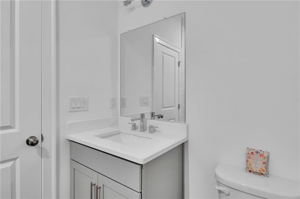 545 Whitlox Road Northwest Atlanta, GA 30309 - Photo 48 of 65 a bathroom with a sink vanity and a mirror