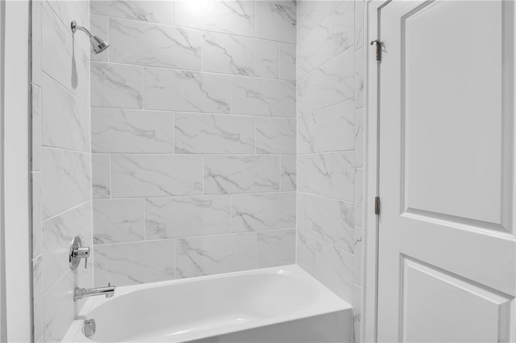 545 Whitlox Road Northwest Atlanta, GA 30309 - Photo 49 of 65 a bathroom with a bathtub