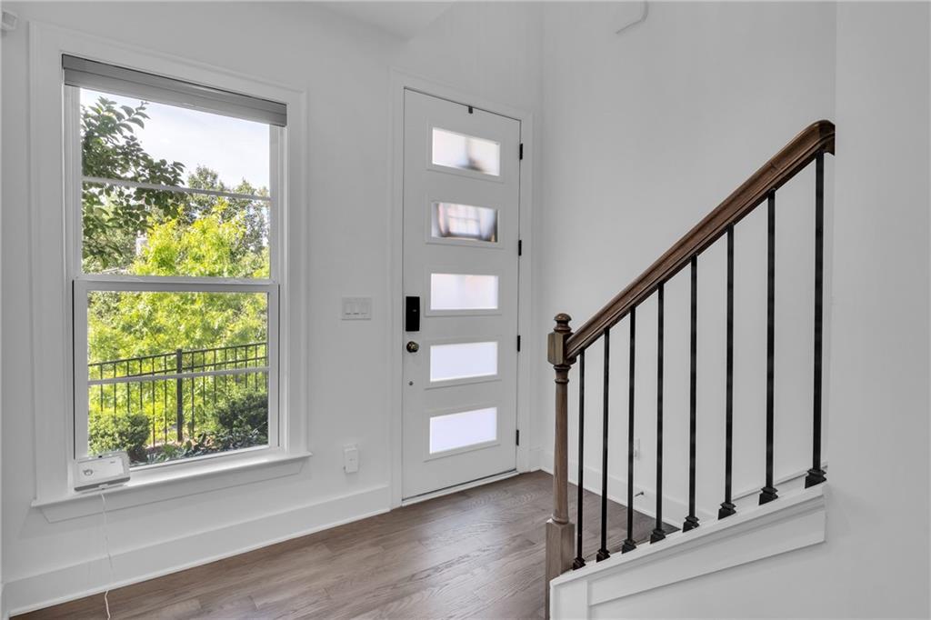 545 Whitlox Road Northwest Atlanta, GA 30309 - Photo 50 of 65 a view of staircase with wooden floor and a window