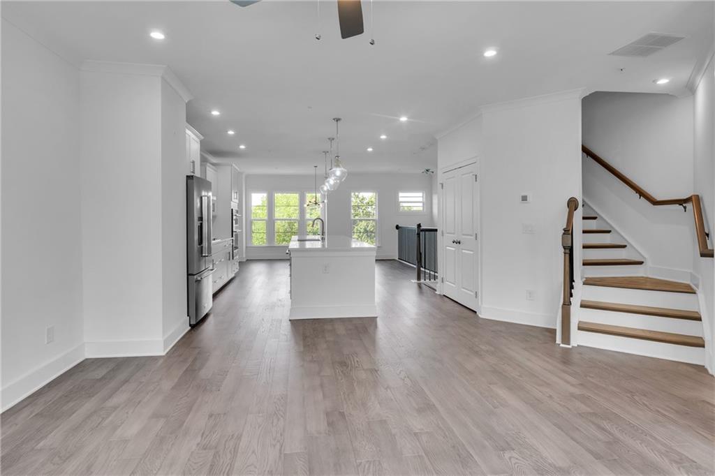 545 Whitlox Road Northwest Atlanta, GA 30309 - Photo 5 of 65 an empty room with wooden floor and windows