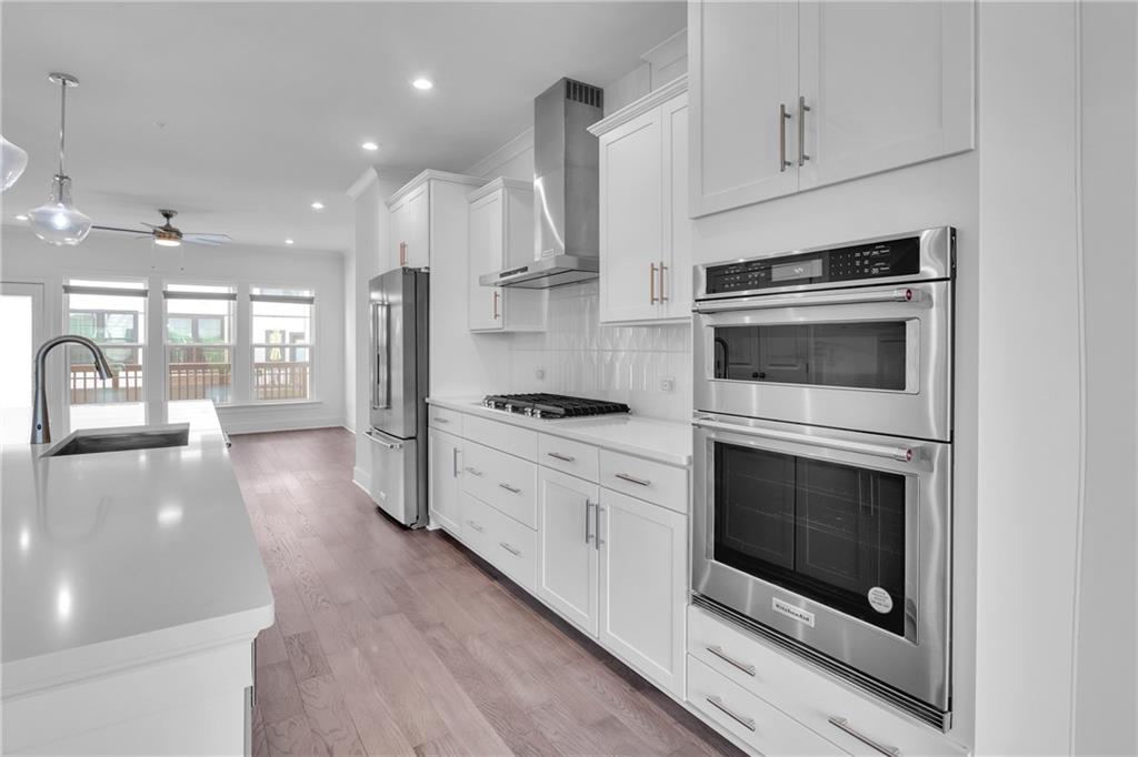 545 Whitlox Road Northwest Atlanta, GA 30309 - Photo 10 of 65 a kitchen with stainless steel appliances granite countertop a stove a sink and a refrigerator