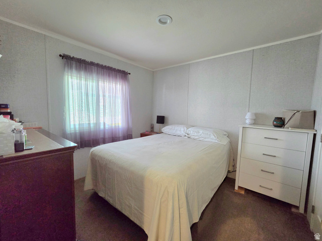 597 North State Street, Unit 67 Orem, UT 84057 - Photo 15 of 23 Bedroom with dark colored carpet and crown molding