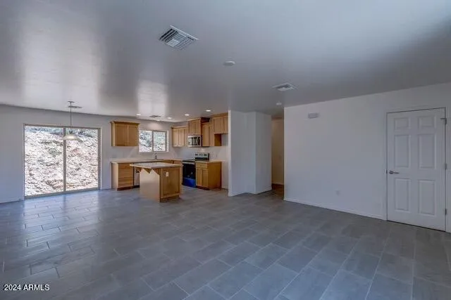 a view of a kitchen with a stove cabinets and a living room