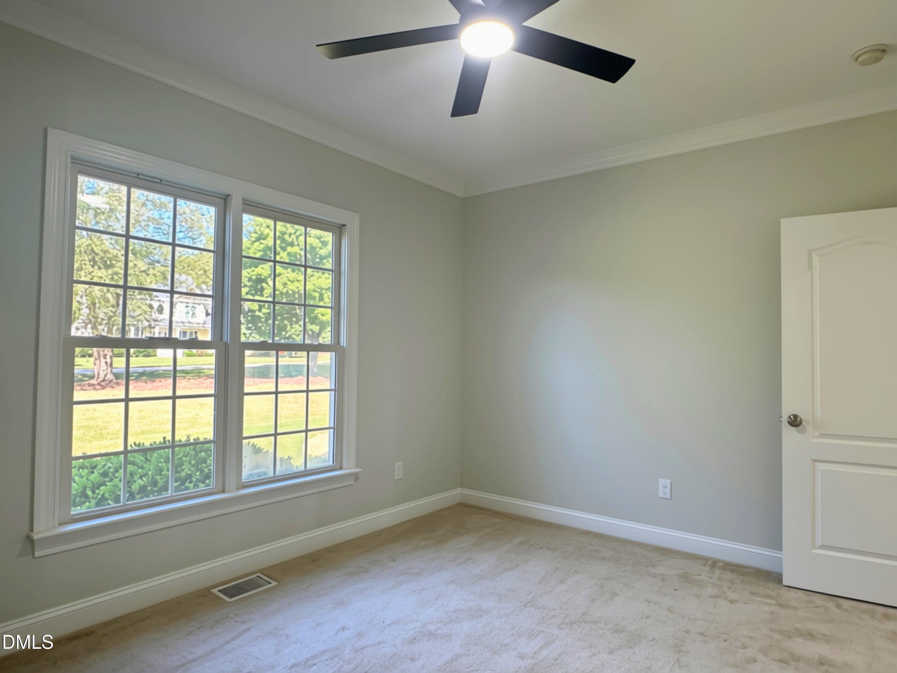 3100 Donlin Drive Wake Forest, NC 27587 - Photo 33 of 67 Double-hung windows, crown molding, ceiling fan with integrated lighting, and carpeted flooring
