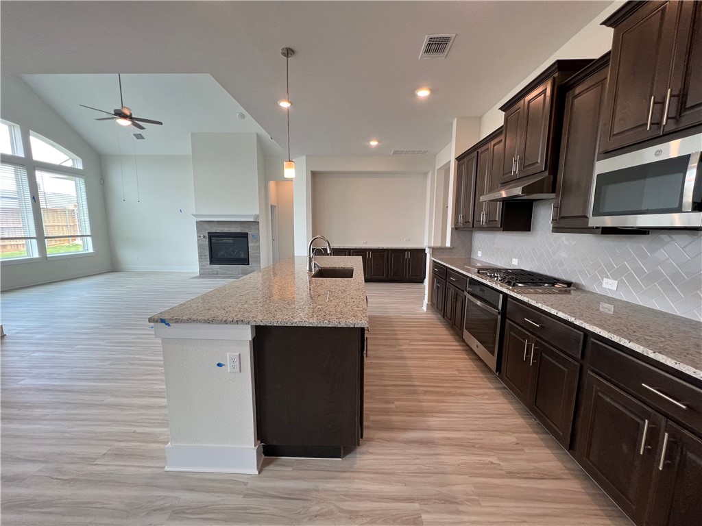 982 Wild Pecan Loop Buda, TX 78610 - Photo 6 of 16 SS appliances, Granite countertops and cabinets galore in this sleek and open kitchen