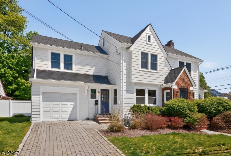 909 Ridgewood Road Millburn, NJ 07041 - Photo 24 of 33 a front view of a house with a yard
