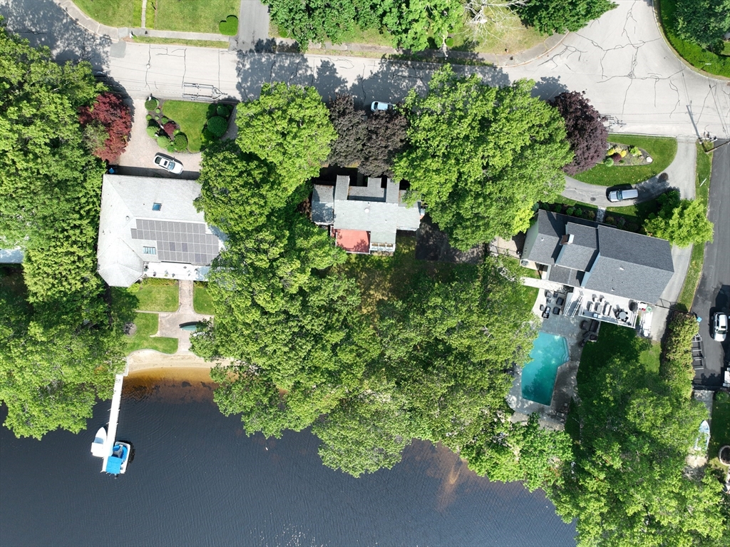 an aerial view of a house with a yard and garden