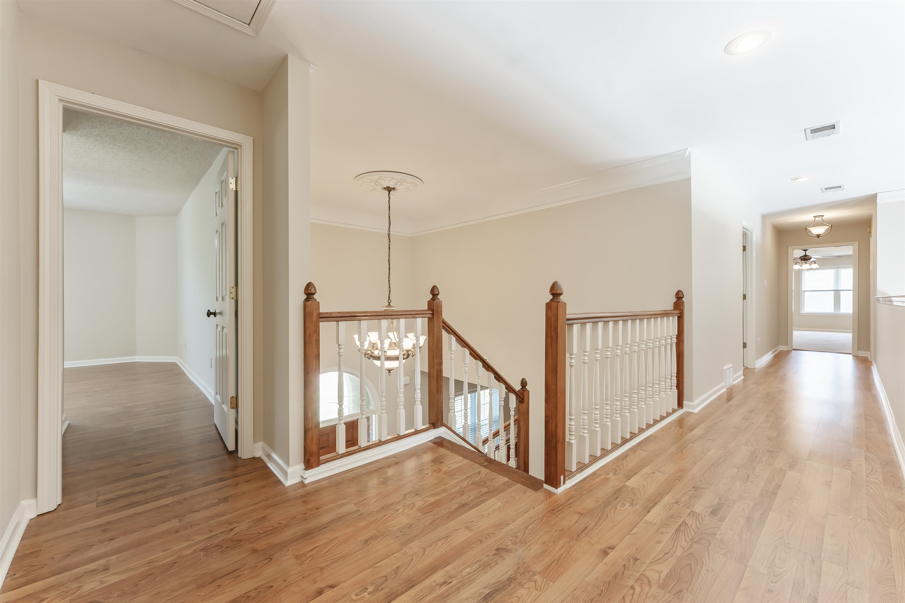 4279 High Plains Road Bartlett, TN 38135 - Photo 21 of 37 Upper level landing featuring wood-finish flooring, white baseboards, and crown molding
