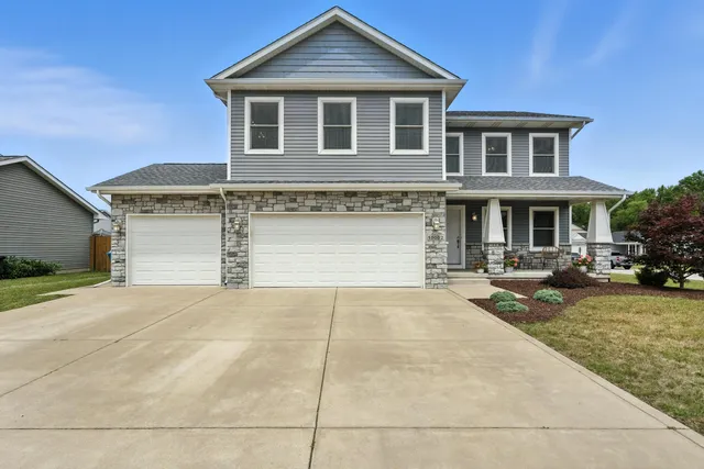 a front view of a house with a yard and garage